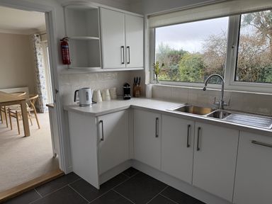 A kitchen with sink and kettle at 42 Little Trelyn in Rock
