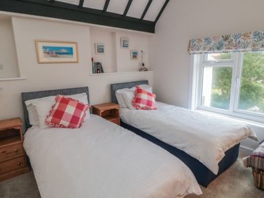 A bedroom with two beds and artwork on the wall at Iveridge in Sandsend