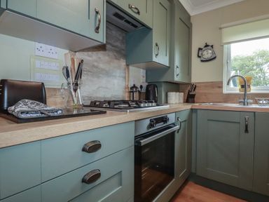 A kitchen featuring appliances and cabinetry at Lodge 9 - Lamorna, Tregolds near St Merryn