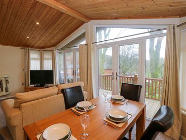 A dining room with a table and chairs at Wansfell 2 Limefitt Park near Troutbeck