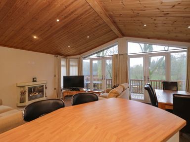 A living room with a television and sofa at Wansfell 2 Limefitt Park near Troutbeck