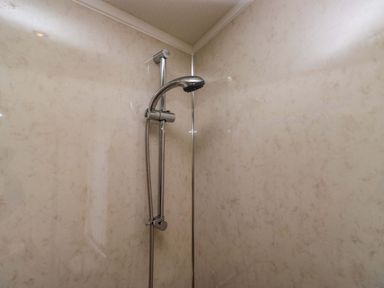 A shower with a chrome shower head at Wansfell 2 Limefitt Park near Troutbeck