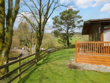 An outdoor view of a property with trees and a road at Wansfell 2 Limefitt Park near Troutbeck