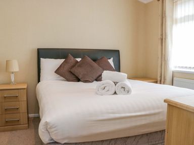 A bedroom with a bed and nightstand at Wansfell 2 near Limefitt Park