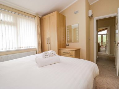 A bedroom with a double bed and wardrobe at Wansfell 2 Limefitt Park near Troutbeck