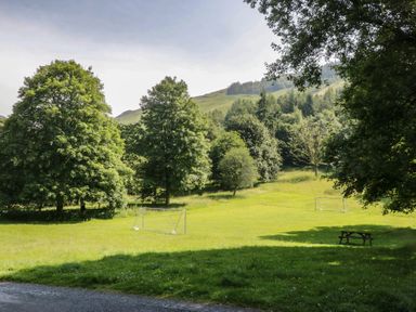 A park with trees and goalposts at Wally's Folly Limefitt Park near Troutbeck