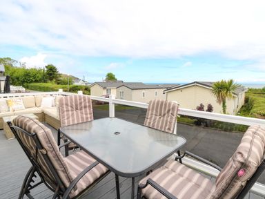 An outdoor seating area with a table and chairs at Ty Seren in New Quay
