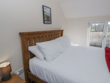 A bedroom with a bed and a bedside lamp at Glandwr House Crossgates near Llandrindod Wells