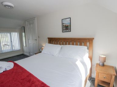 A bedroom with a bed and nightstand at Glandwr House Crossgates near Llandrindod Wells