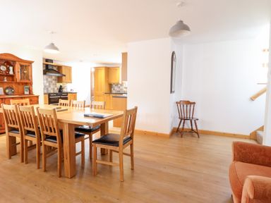 A dining area with a table and chairs at Gwernffridd