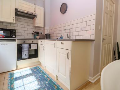 A kitchen with appliances and a sink at The Cow Shed