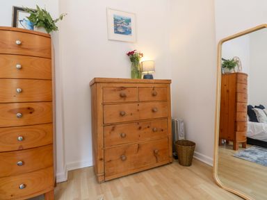 A bedroom with dresser and mirror at The Cow Shed in 