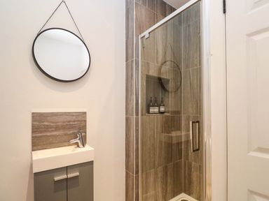A bathroom with a shower and sink at The Cow Shed in 