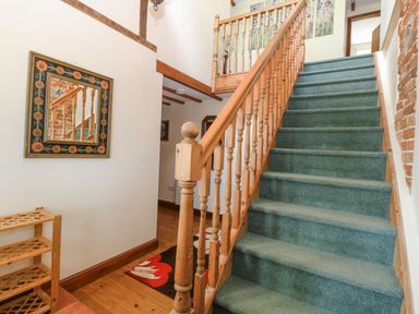 A staircase leading to the upper floor at Lakeside Barn Aylsham