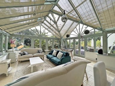A conservatory with sofas and a coffee table at Trenare in Truro