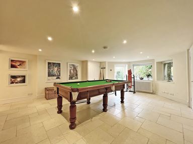 A game room with a pool table and framed posters at Trenare in Truro