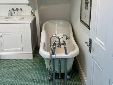 A bathroom with a bathtub and sink at Trenare in Truro