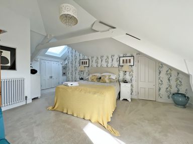 A bedroom with a bed and bedside table at Trenare in Truro