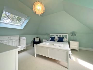 A bedroom with a bed and a baby crib at Trenare in Truro