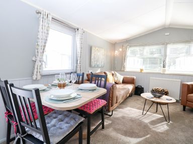 A living room with a dining area and seating at Number 34 Foxburrow Hang in Great Yarmouth