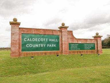 A sign for Caldecott Hall Country Park with amenities listed at Caldecott Hall Country Park in Great Yarmouth