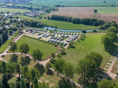 An aerial view of a caravan park surrounded by green fields and trees at Aquadrome Abode - Billing Aquadrome Holiday Park