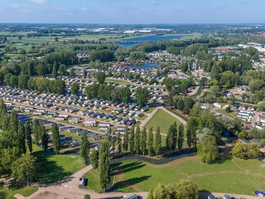 An aerial view of a holiday park with numerous caravans and trees at Aquadrome Abode Billing Aquadrome