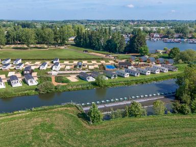 Aerial view of a holiday park with caravans near a river and trees at Lakeside Lullaby - Billing Aquadrome
