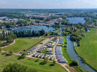An aerial view of a holiday park with caravans near lakes and greenery at Moonlit Skylight - Billing Aquadrome in Billing Aquadrome Holiday Park