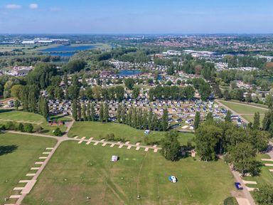 An aerial view of a caravan park with multiple caravans trees and water bodies at Willowbrook Hideaway - Billing Aquadrome Holiday Park