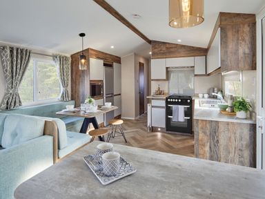 A kitchen with seating area and appliances at Island Breeze - Hayling Island