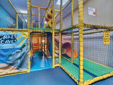 An indoor play area with nets and slides at Island Breeze - Hayling Island