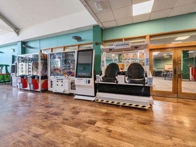 An indoor arcade area with various gaming machines at Golden Dune - Hayling Island