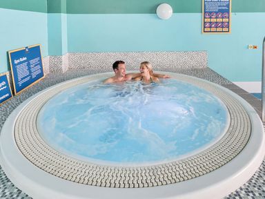 A jacuzzi with two people at Golden Dune - Hayling Island