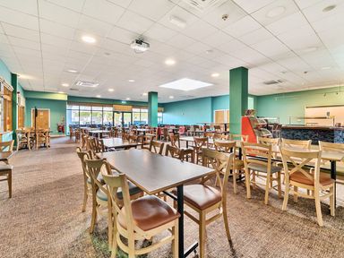 A dining room with tables and chairs at The Lookout - Hayling Island
