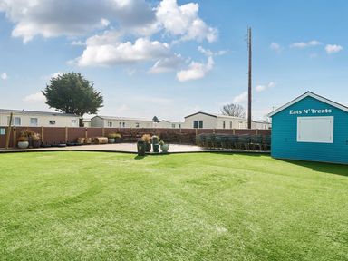 An outdoor area with a food shack and seating at The Lookout - Hayling Island