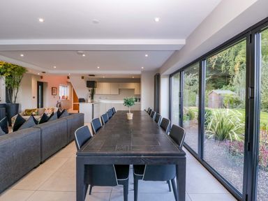 A dining room with a table and chairs at Forest Lodge in Pontyclun