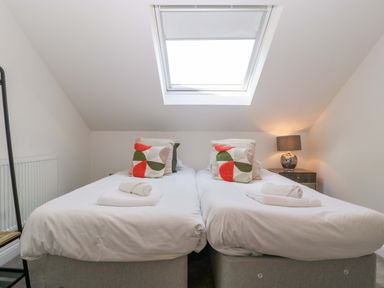 A bedroom with two beds and a lamp at Forest Lodge in Pontyclun