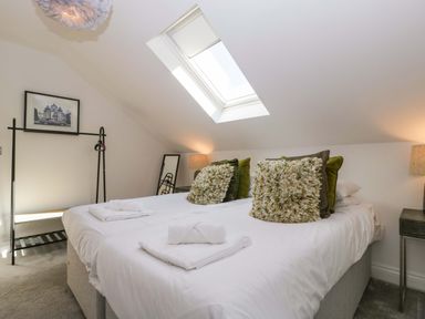 A bedroom with two beds and a skylight at Forest Lodge in Pontyclun