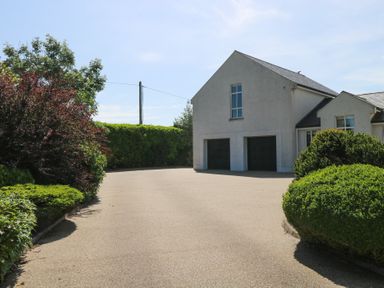 A house with garage and driveway at The East Wing Apartment in Claremorris