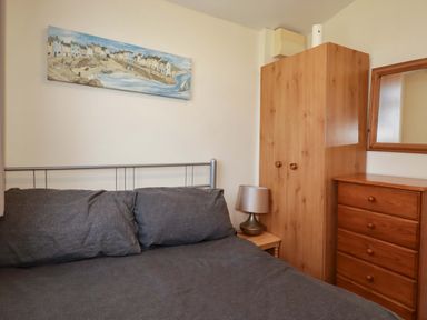 A bedroom with a bed and wooden furniture at 101 Atlantic Bays Holiday Park in Padstow