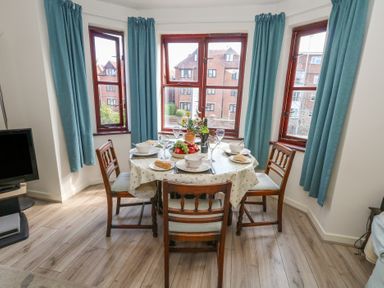 A dining room with a table set for a meal at Flat 9 in Swanage