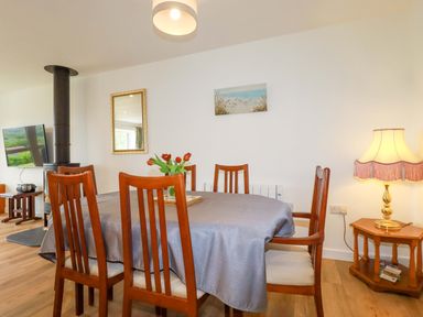 A dining room with a table and chairs at Folly View in Cambrose near Illogan