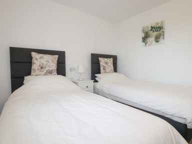 A bedroom with two single beds at Folly View Cambrose near Illogan