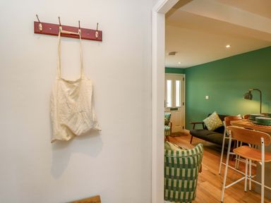 An entryway with a hook rack and canvas bag at No 157 Sandown Bay Holiday Chalet 'Field View' Sandown
