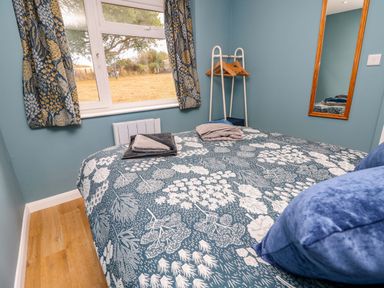 A bedroom with a bed and a window at No 157 Sandown Bay Holiday Chalet 'Field View' Sandown