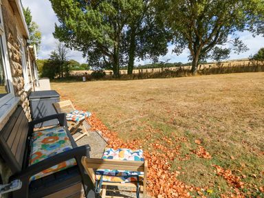 An outdoor area with chairs and grass at No 157 Sandown Bay Holiday Chalet 'Field View' Sandown