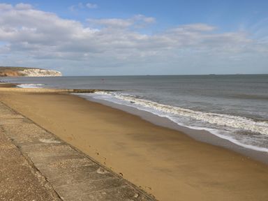 A beach scene with sand and ocean waves at No 157 Sandown Bay Holiday Chalet 'Field View' Sandown
