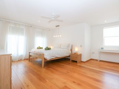 A bedroom with a bed and desk at Shearwater in Rhosneigr