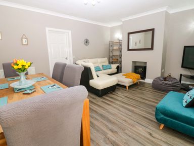 A living room and dining area with furniture at Amblers Rest in Amble